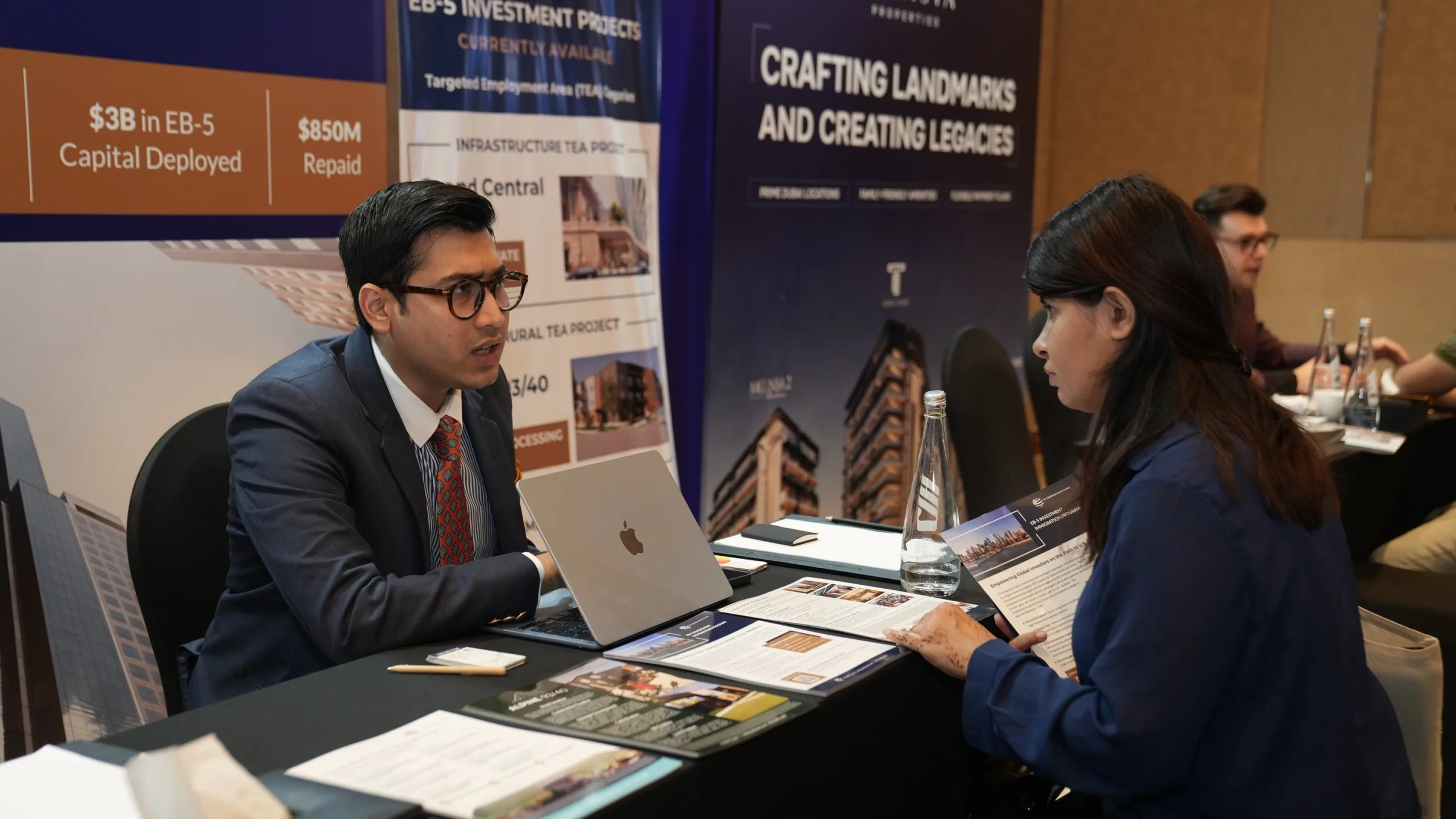 One-on-one discussion with EB-5 investors reviewing rural and infrastructure EB-5 investment options at IREX